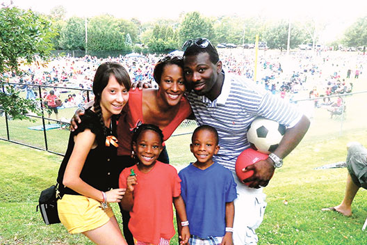 Family playing soccer together